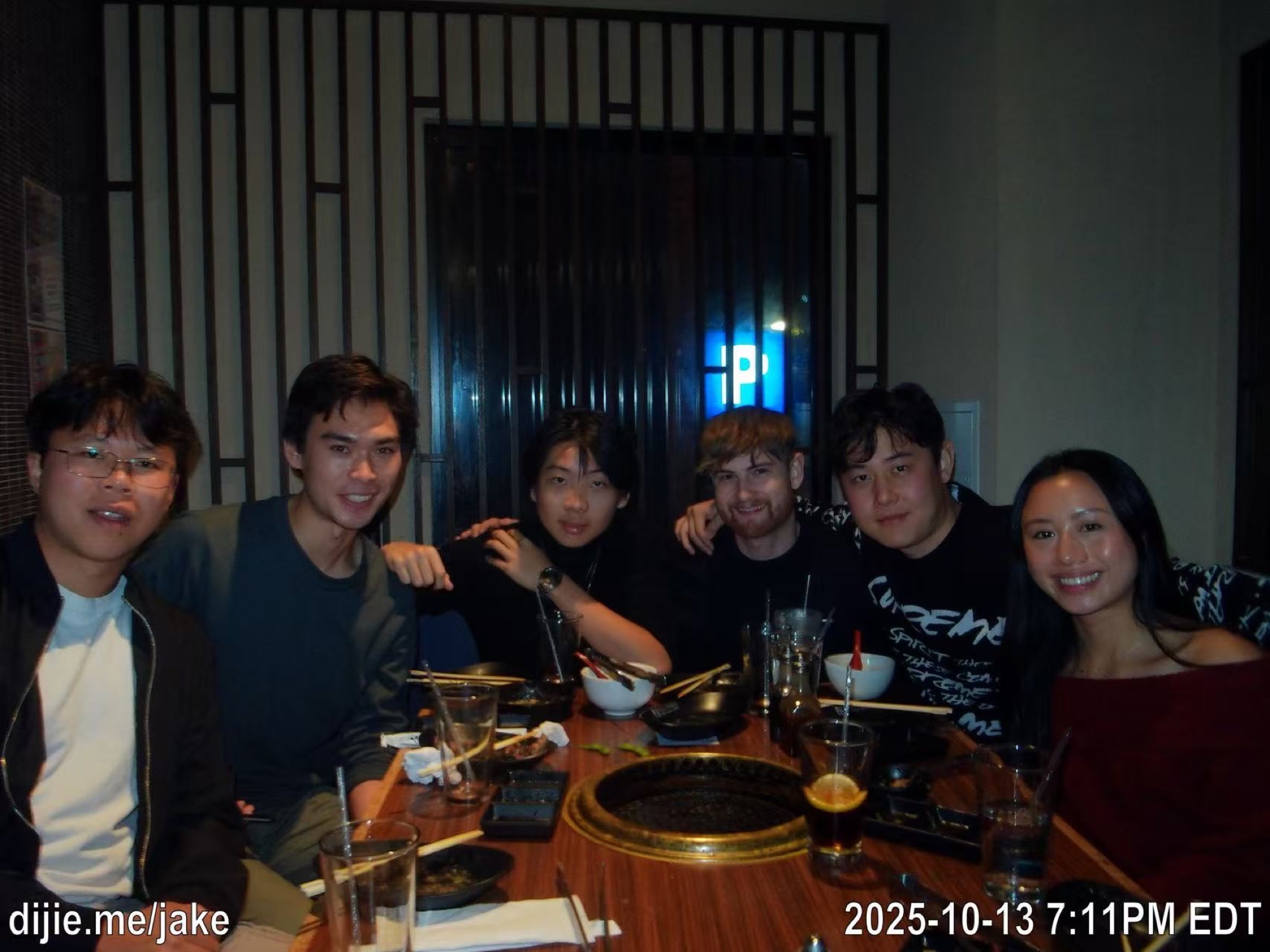 Six friends together at a restaurant table