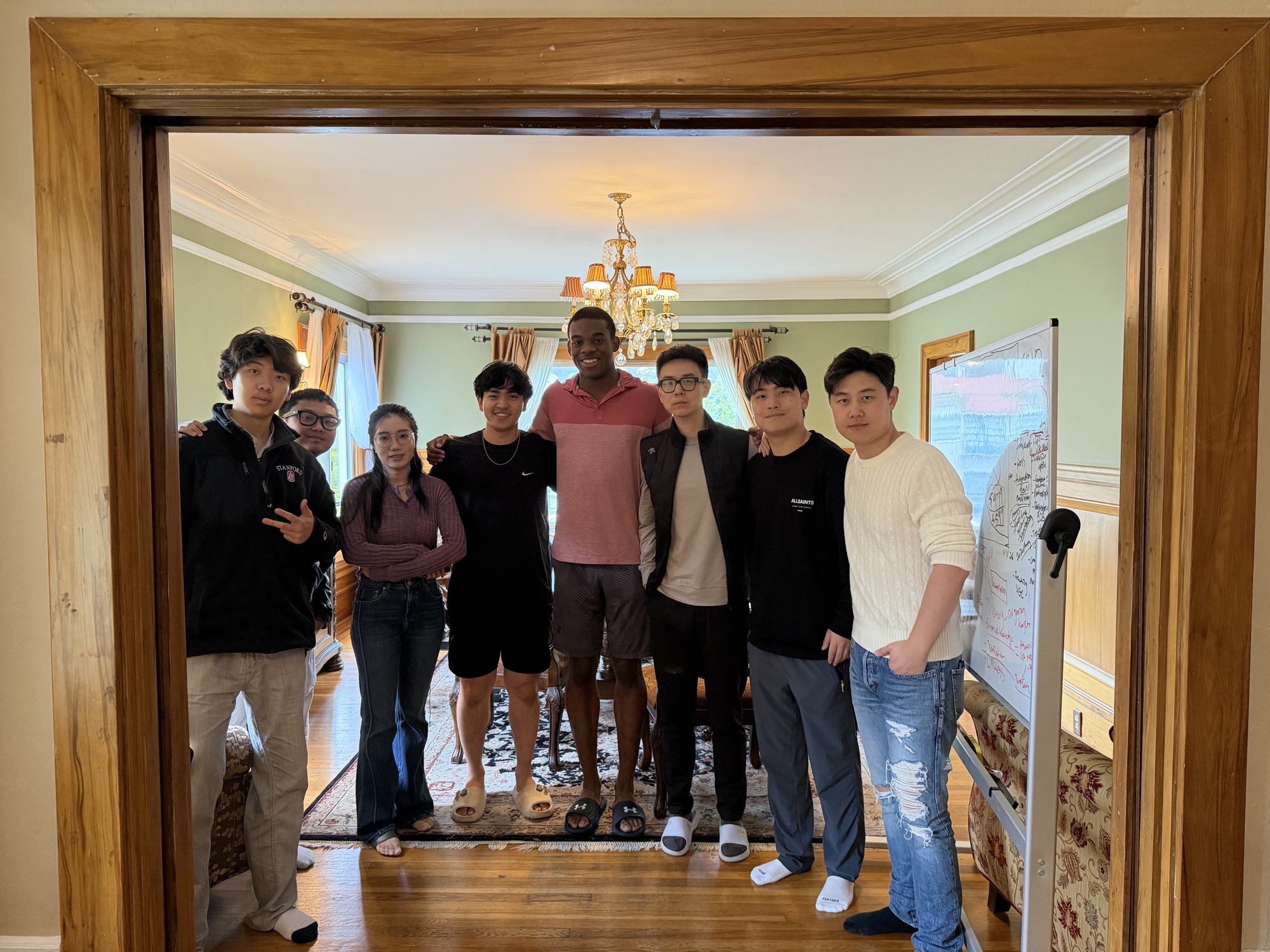 Friends gathered in a house beside a whiteboard